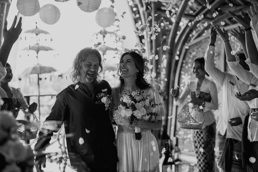 Black and white photo of a wedding celebration with paper lanterns and floral decor.