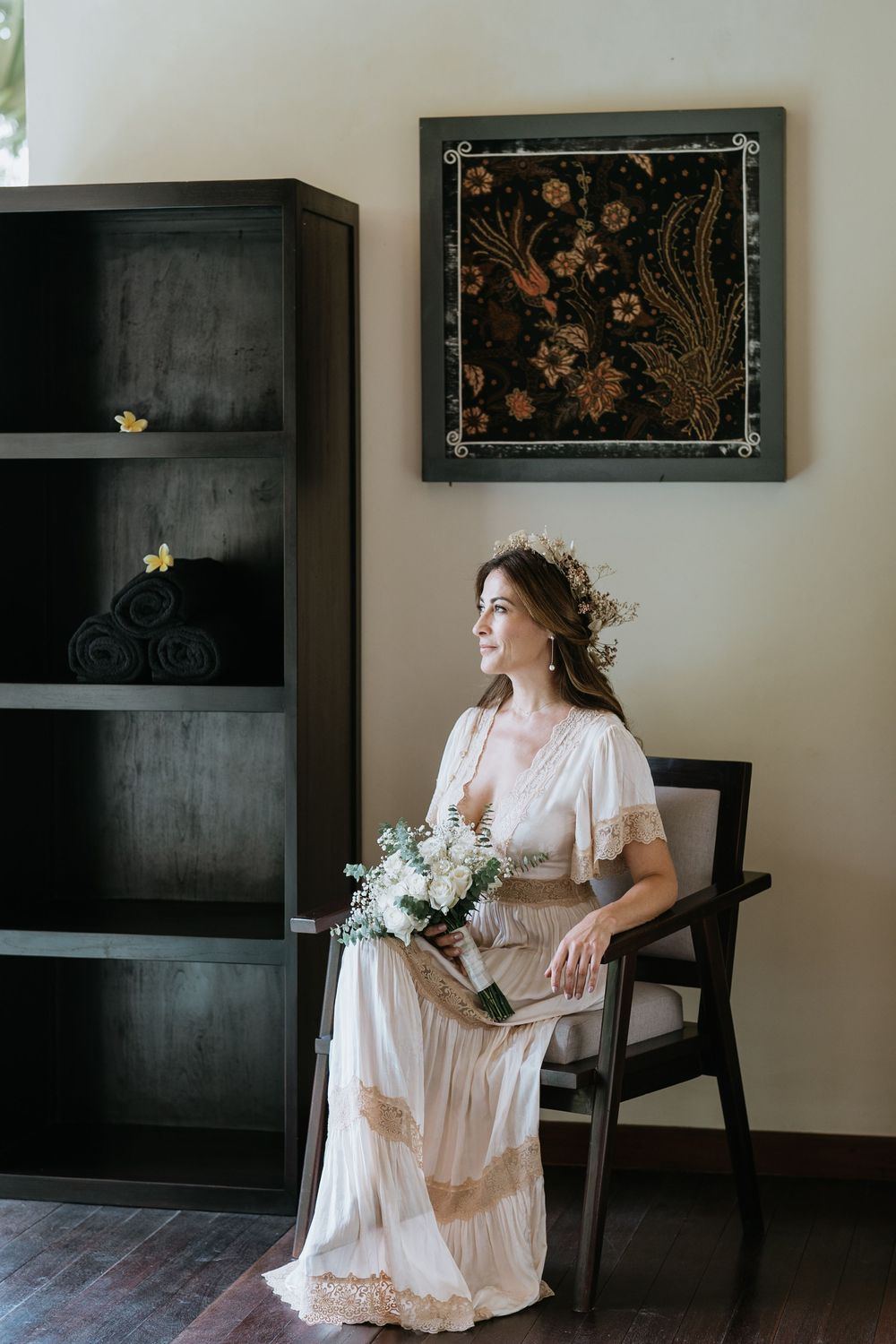 Interior scene with vintage furniture and decorative wall art in muted tones.