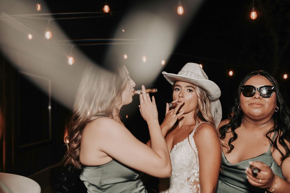 fun wedding reception photos of bride and her crew smoking cigars