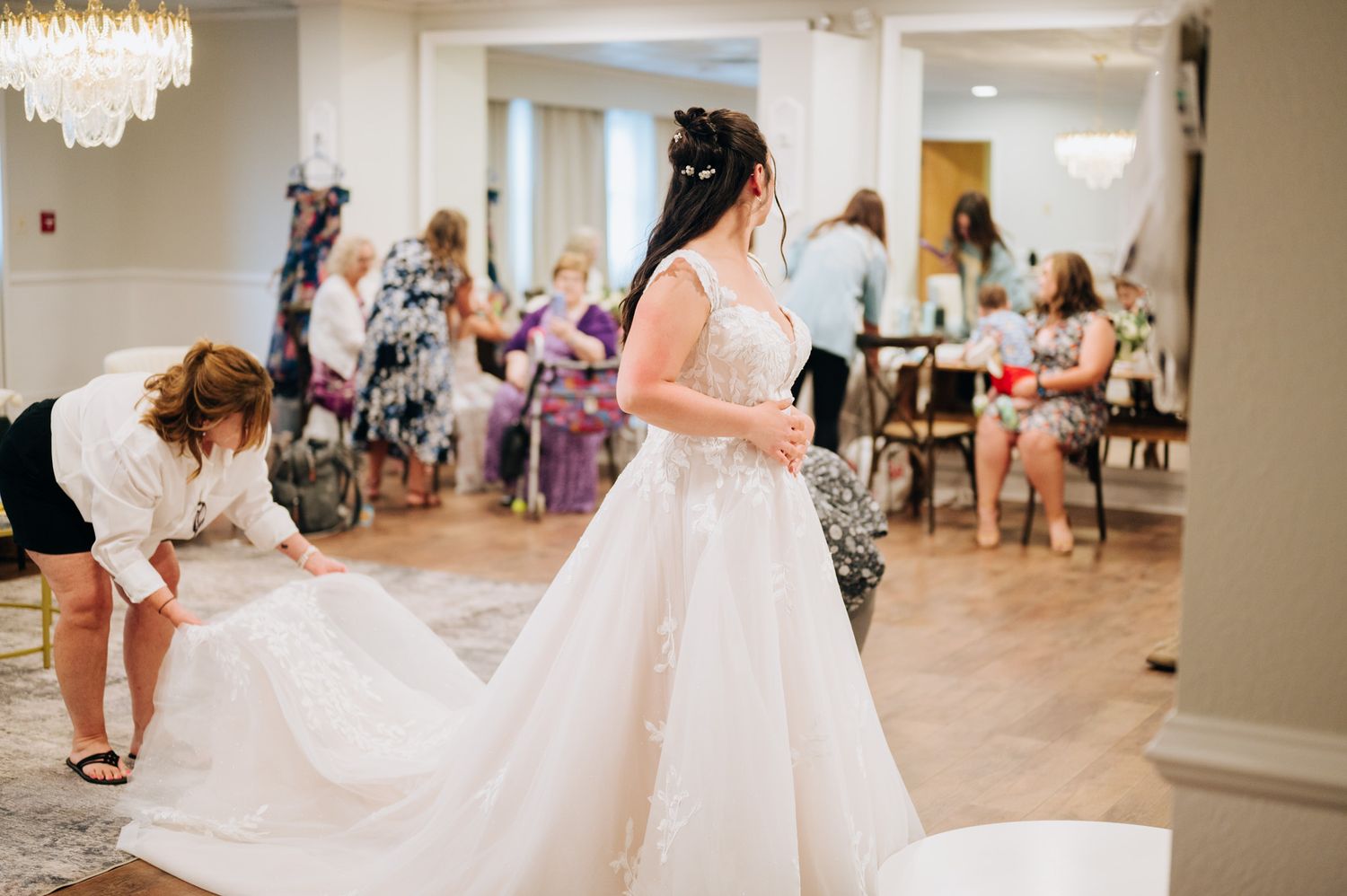 A collection of photos showing a bride in a flowing white lace wedding dress posing in an elegant indoor venue.