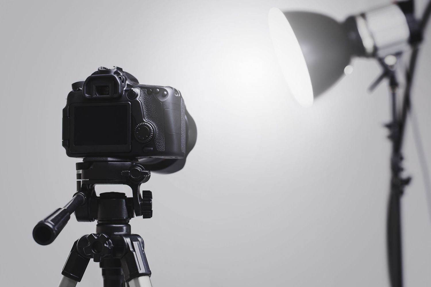 Professional black DSLR camera photographed from multiple angles against a white studio background.