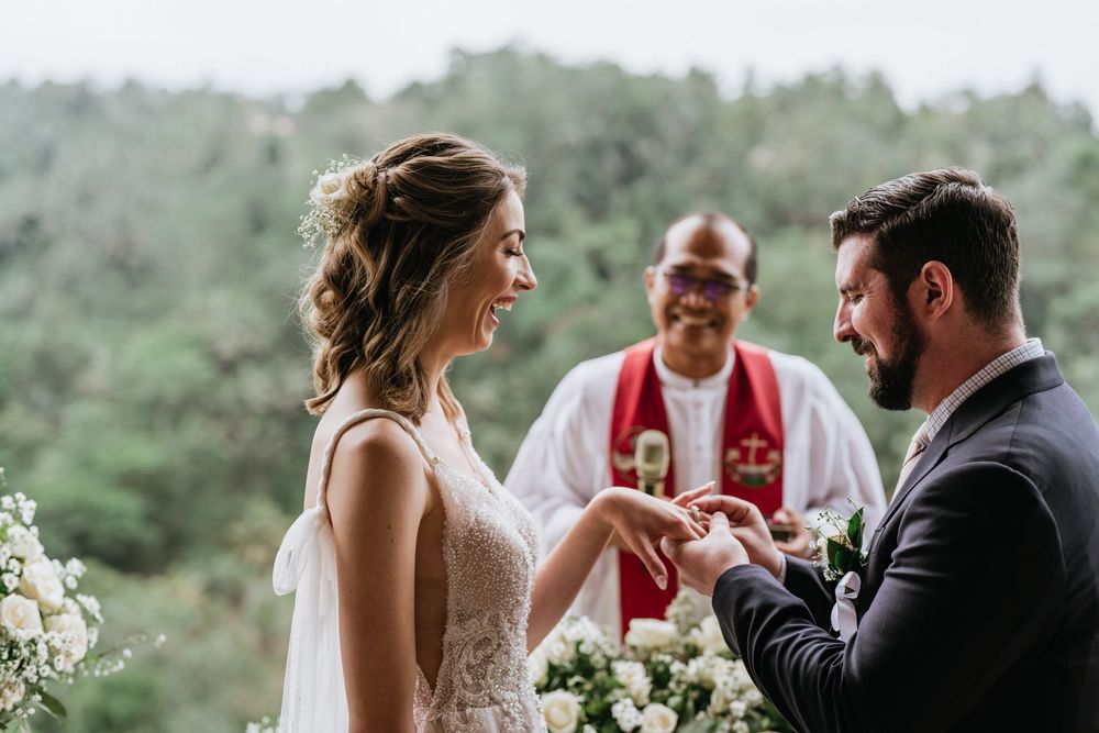 Wedding ceremony taking place in a beautiful outdoor setting with mountain views.