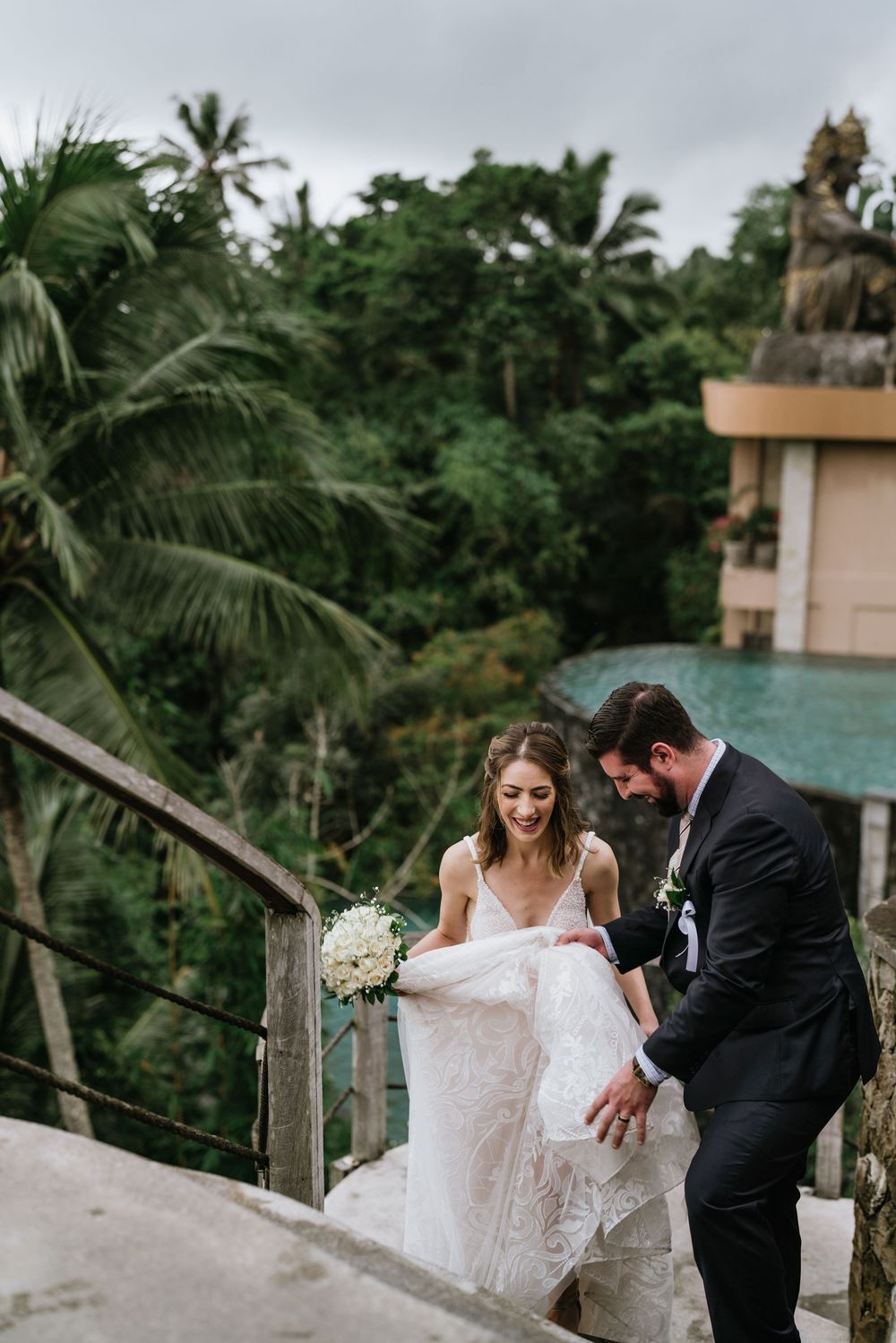 Romantic wedding photos captured on a tropical terrace surrounded by palm trees.