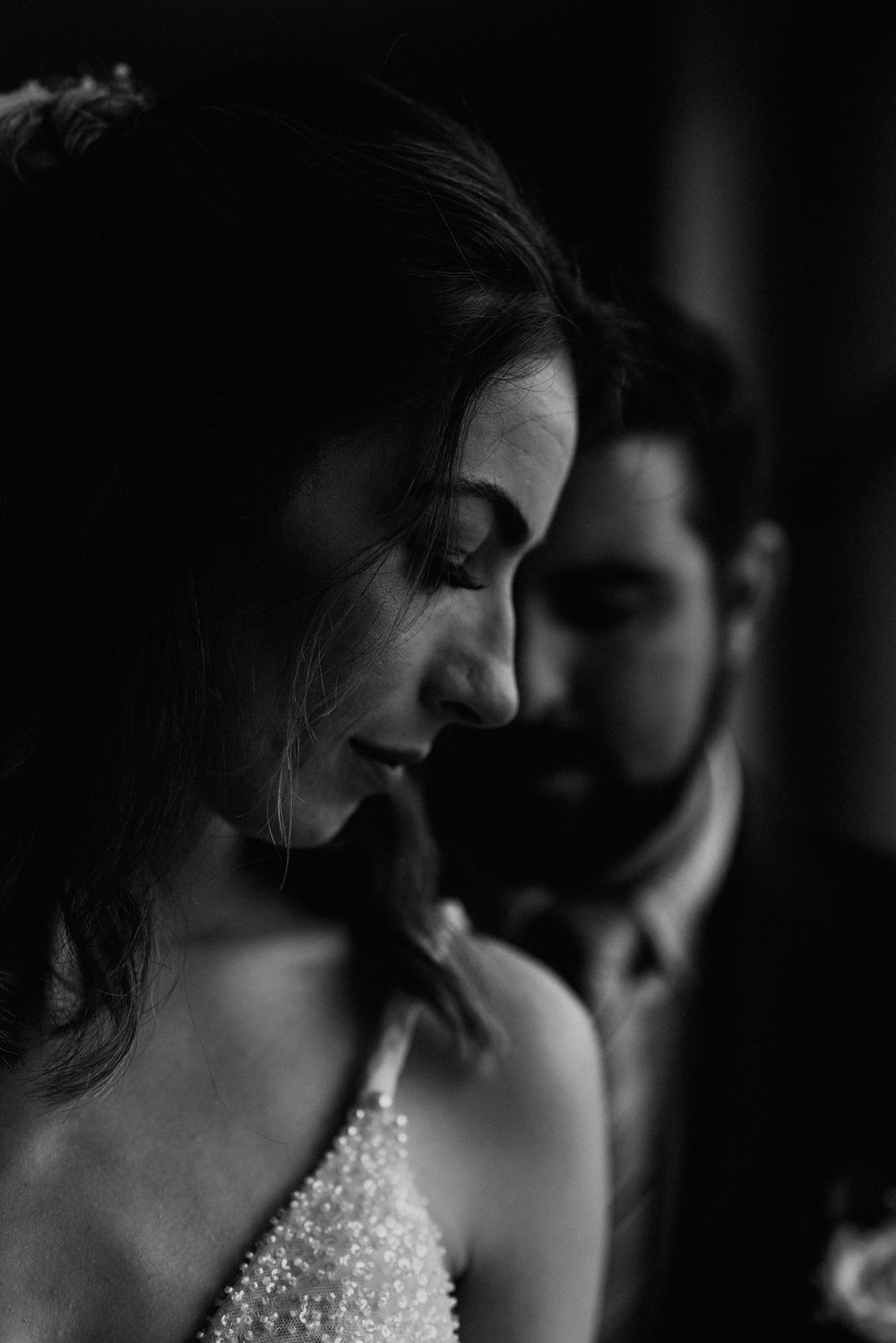 Close-up black and white portrait showing sparkly wedding dress details.