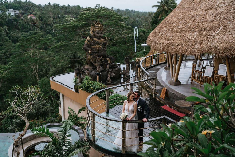 Panoramic view of a luxurious tropical wedding venue surrounded by lush greenery.