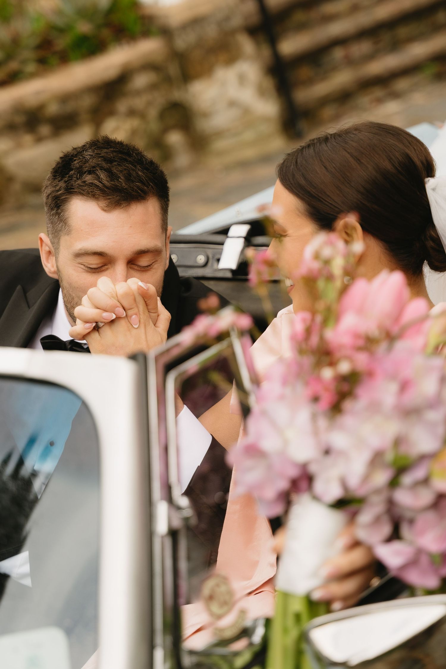 A series of photos showing someone in a car with pink cherry blossoms visible in the foreground.