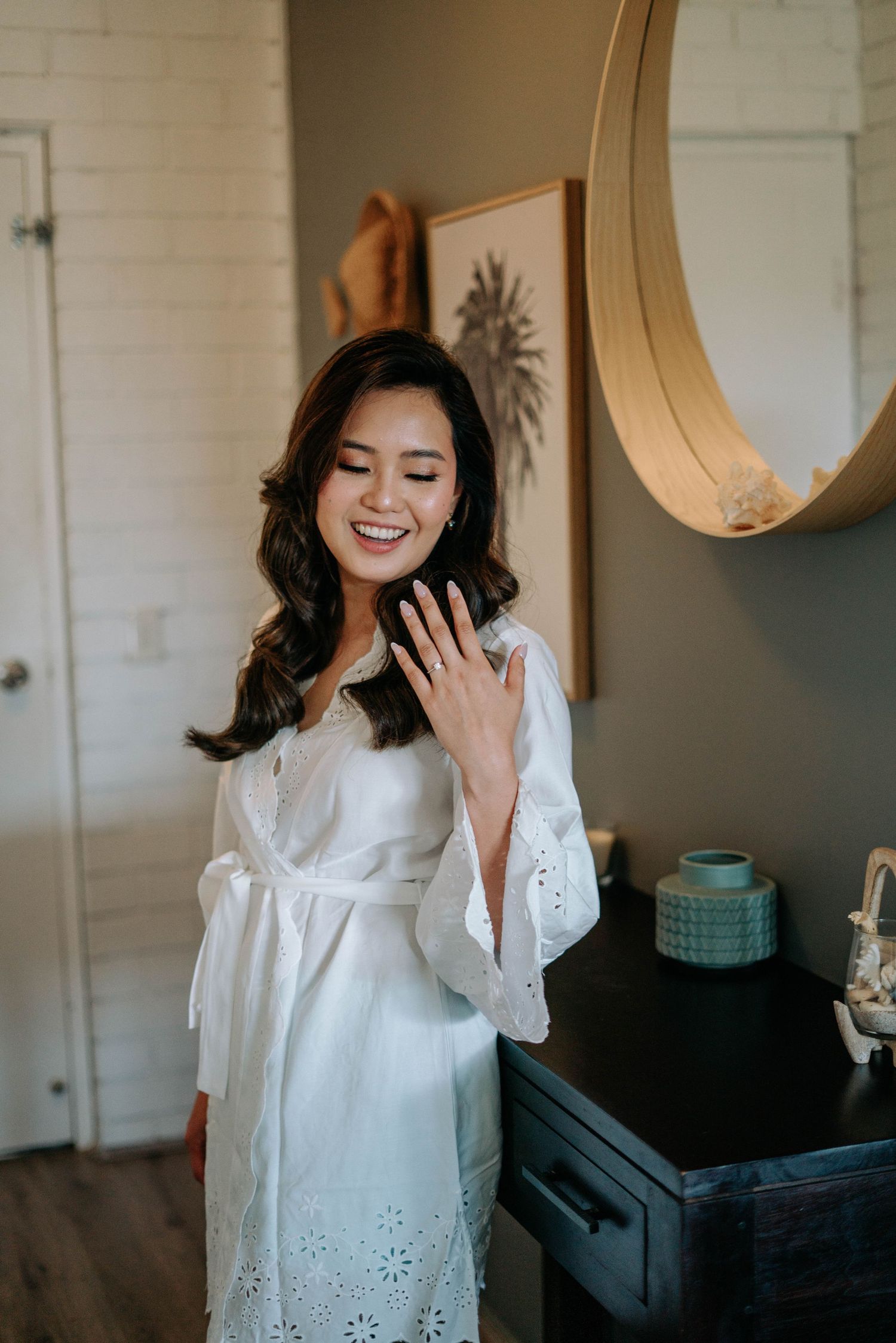 A person in a white eyelet lace top poses and laughs joyfully in a sequence of candid lifestyle photos.
