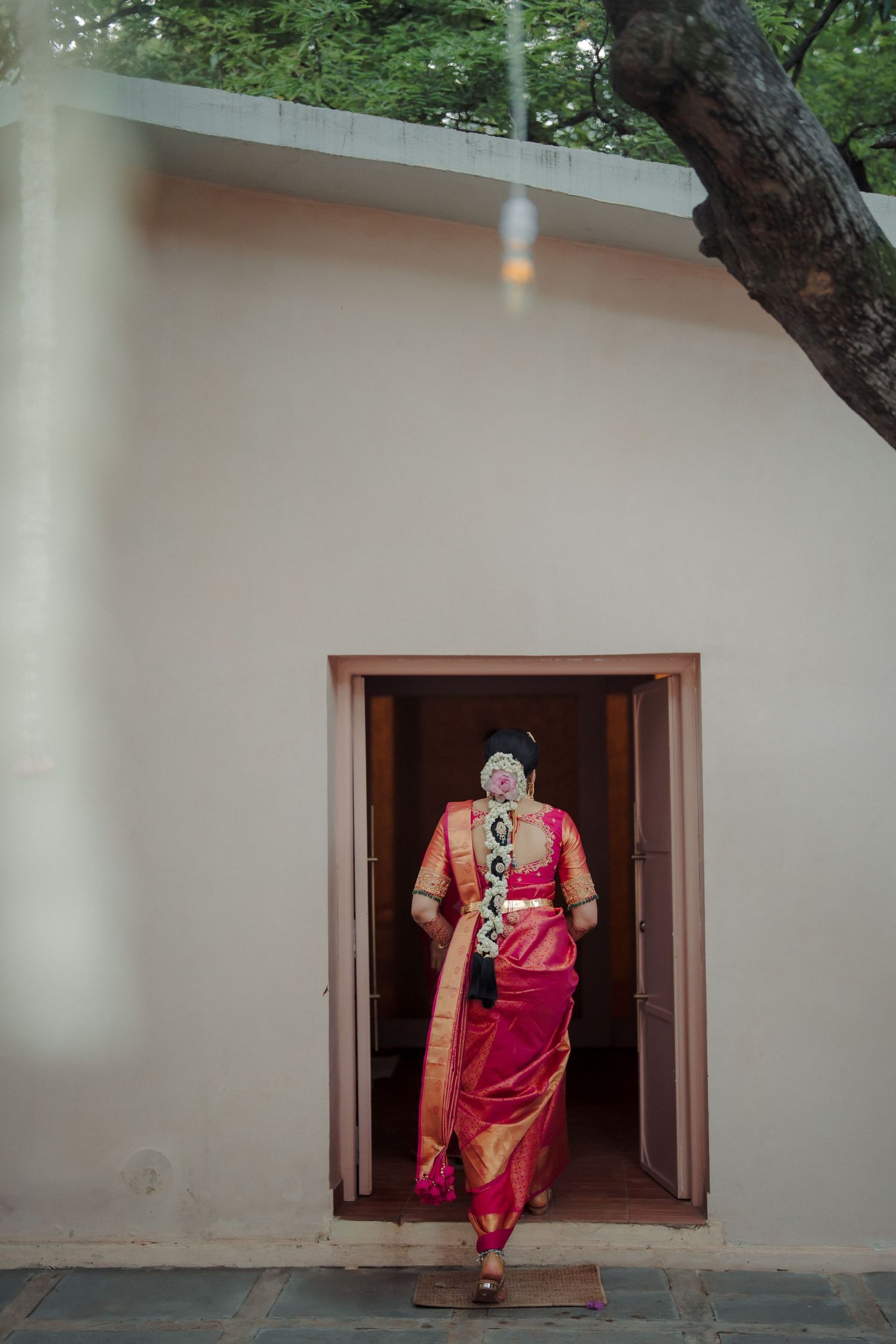 Creative sequence showing person in traditional Indian attire emerging through white wall windows.
