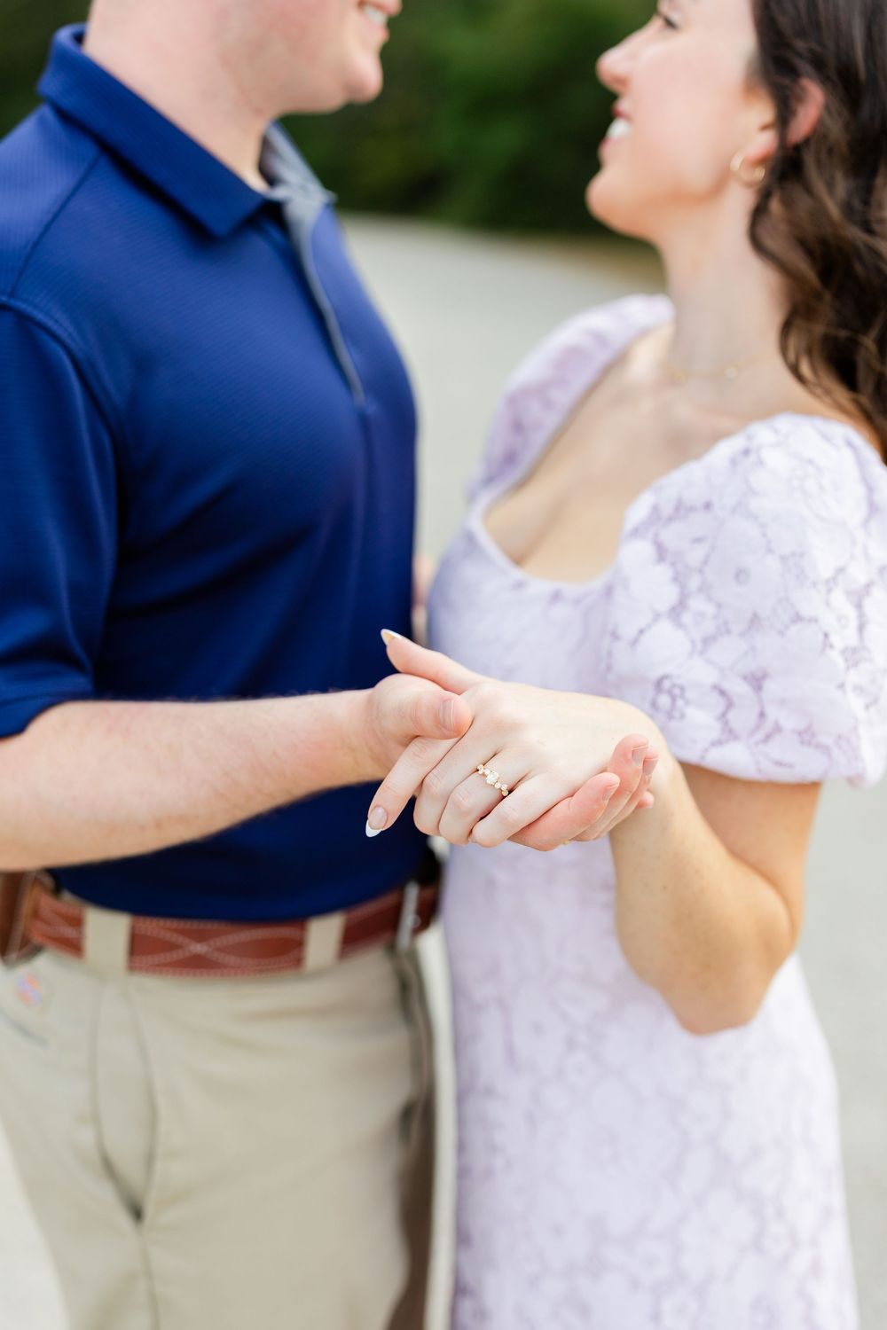 A romantic sequence showing a couple in navy and white outfits holding hands and smiling during an outdoor photoshoot.