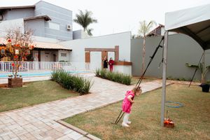 A series of backyard views showing paved walkways, lawn areas, and outdoor living spaces with a simple modern aesthetic.