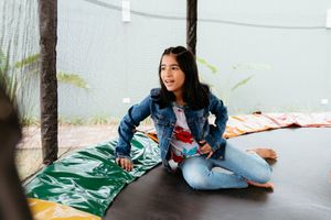 A group of connected photos shows someone resting on cushions on the floor wearing denim and blue clothing.