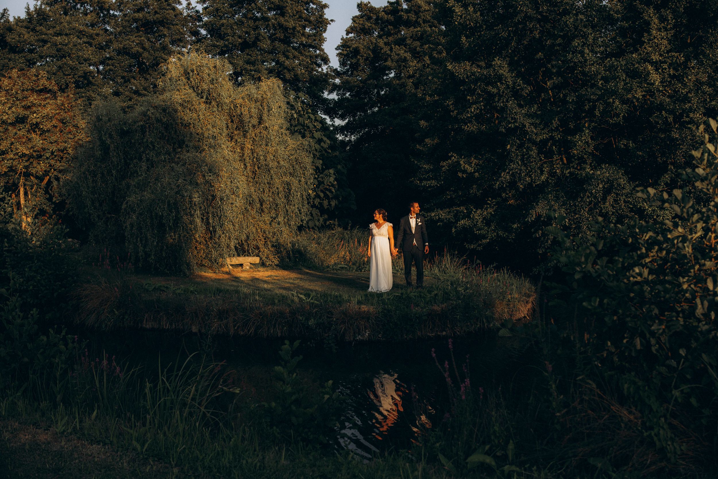 A romantic dance silhouette under stone archways with warm lighting.