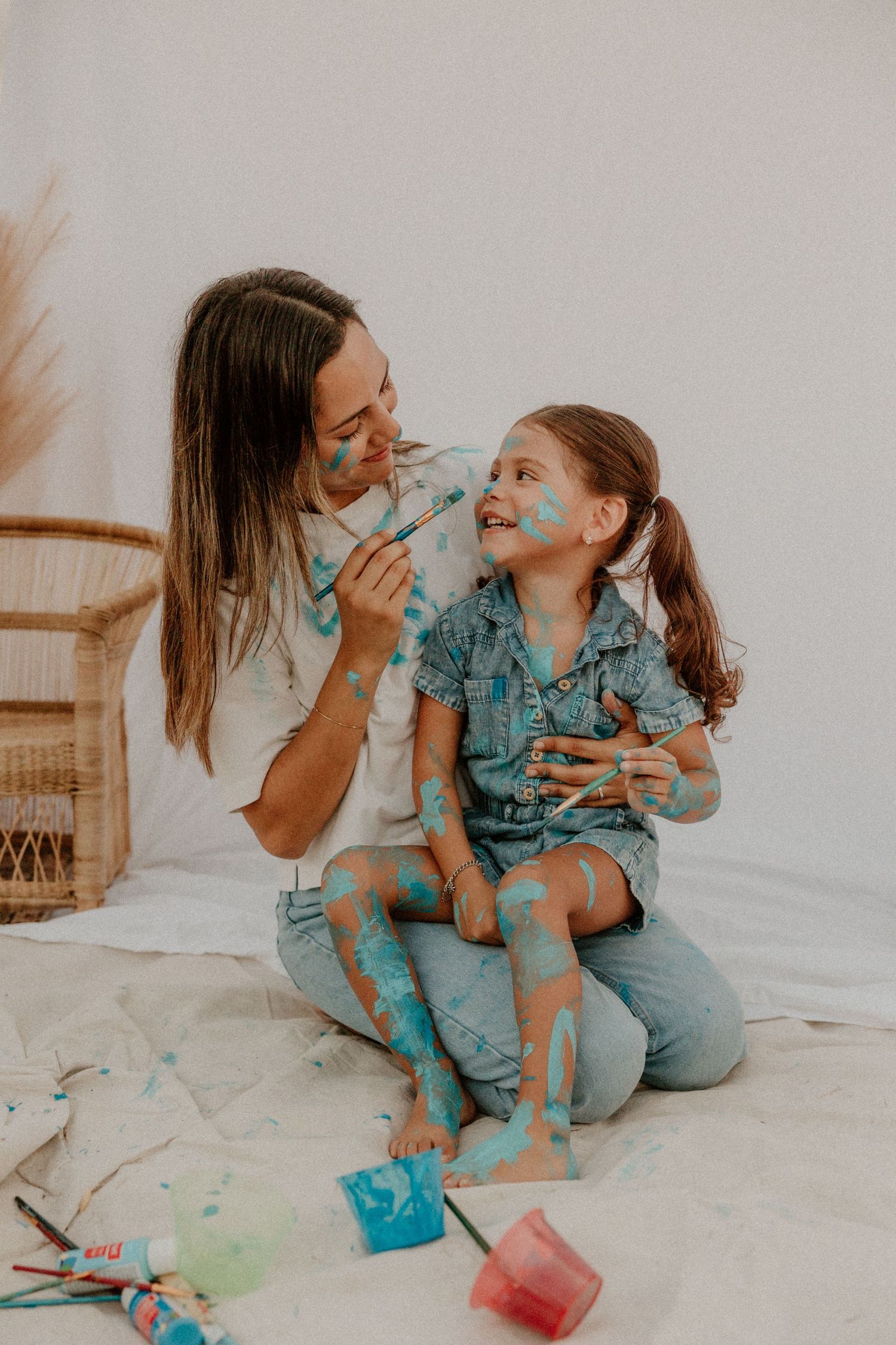 A joyful painting session with blue paint and creative expressions.