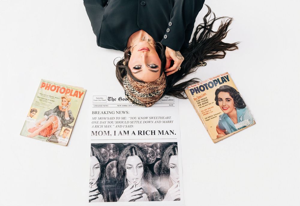 A collection of vintage magazines and printed materials arranged in an artistic flatlay composition on a white background.