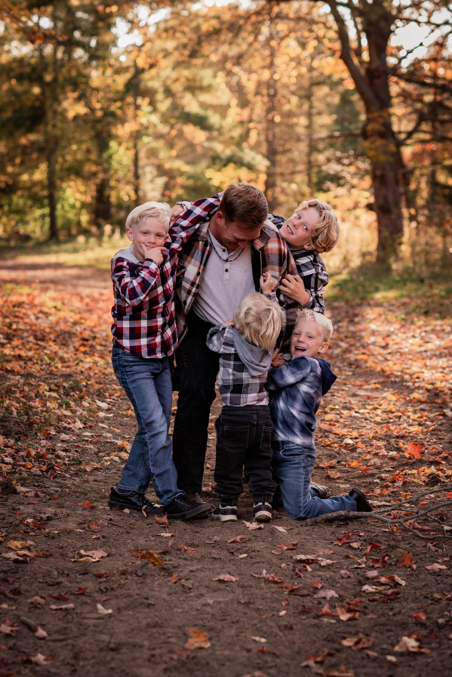 Ontario family photographer capturing a dad with his sons on J&H Ranch in Bolsover.