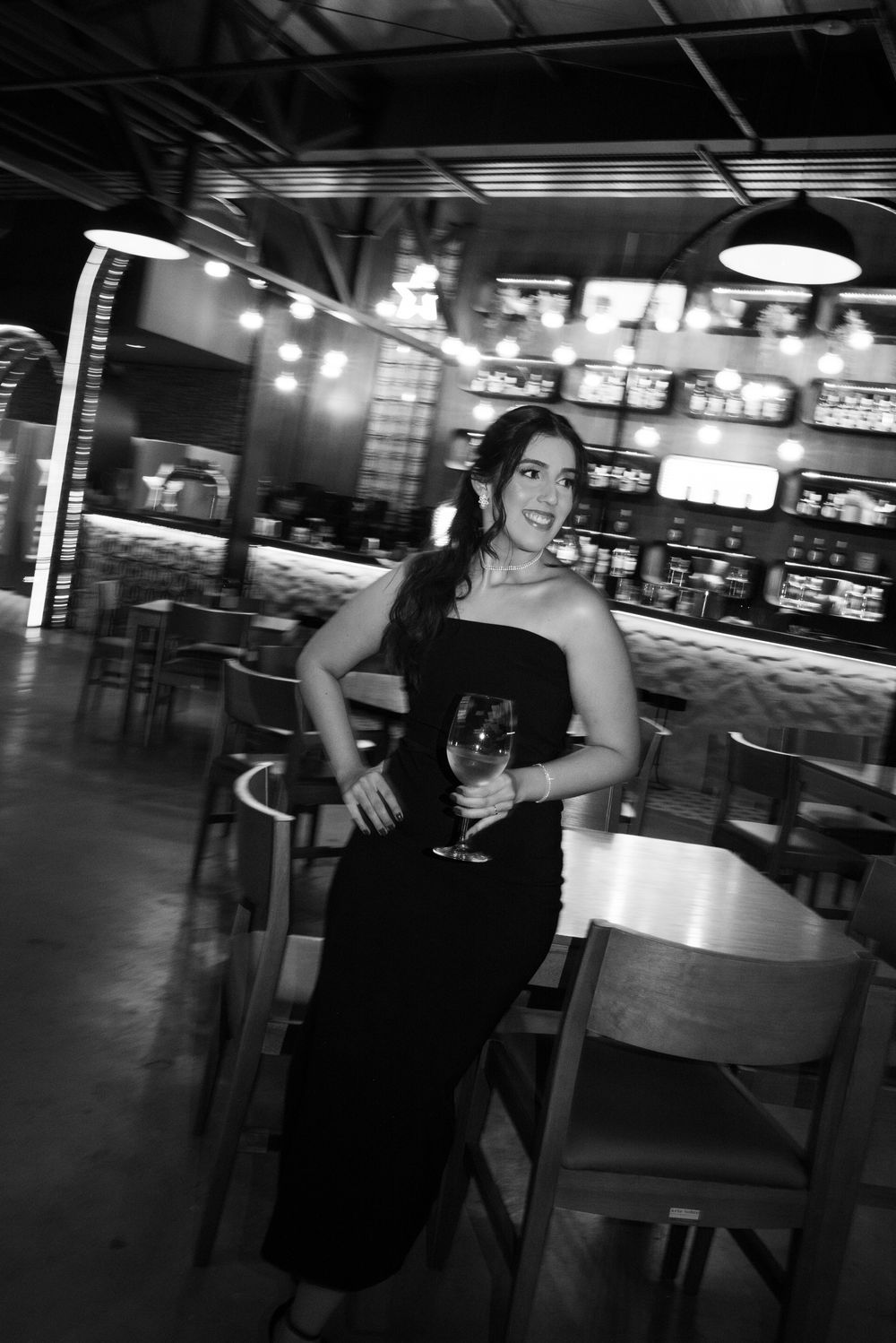 A group of friends dancing and posing together at a dimly lit venue or restaurant.