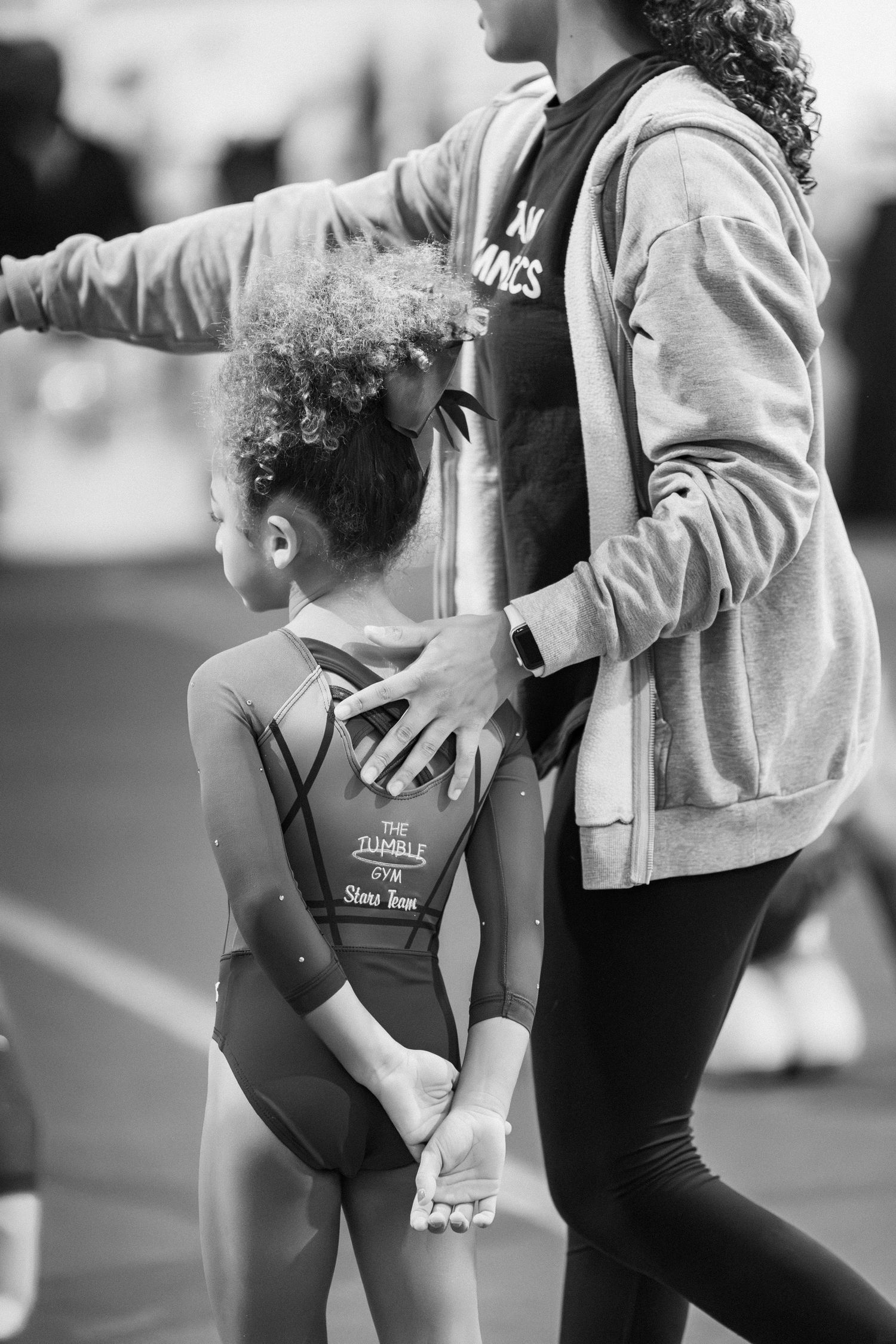 A sequence of black and white photos showing stretching exercises and warmup movements in athletic wear.