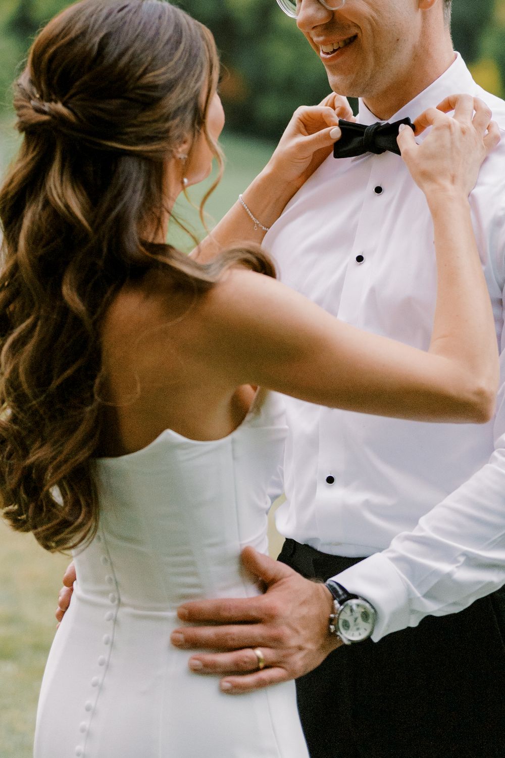 Candid moments of a couple in wedding attire embracing and laughing together.