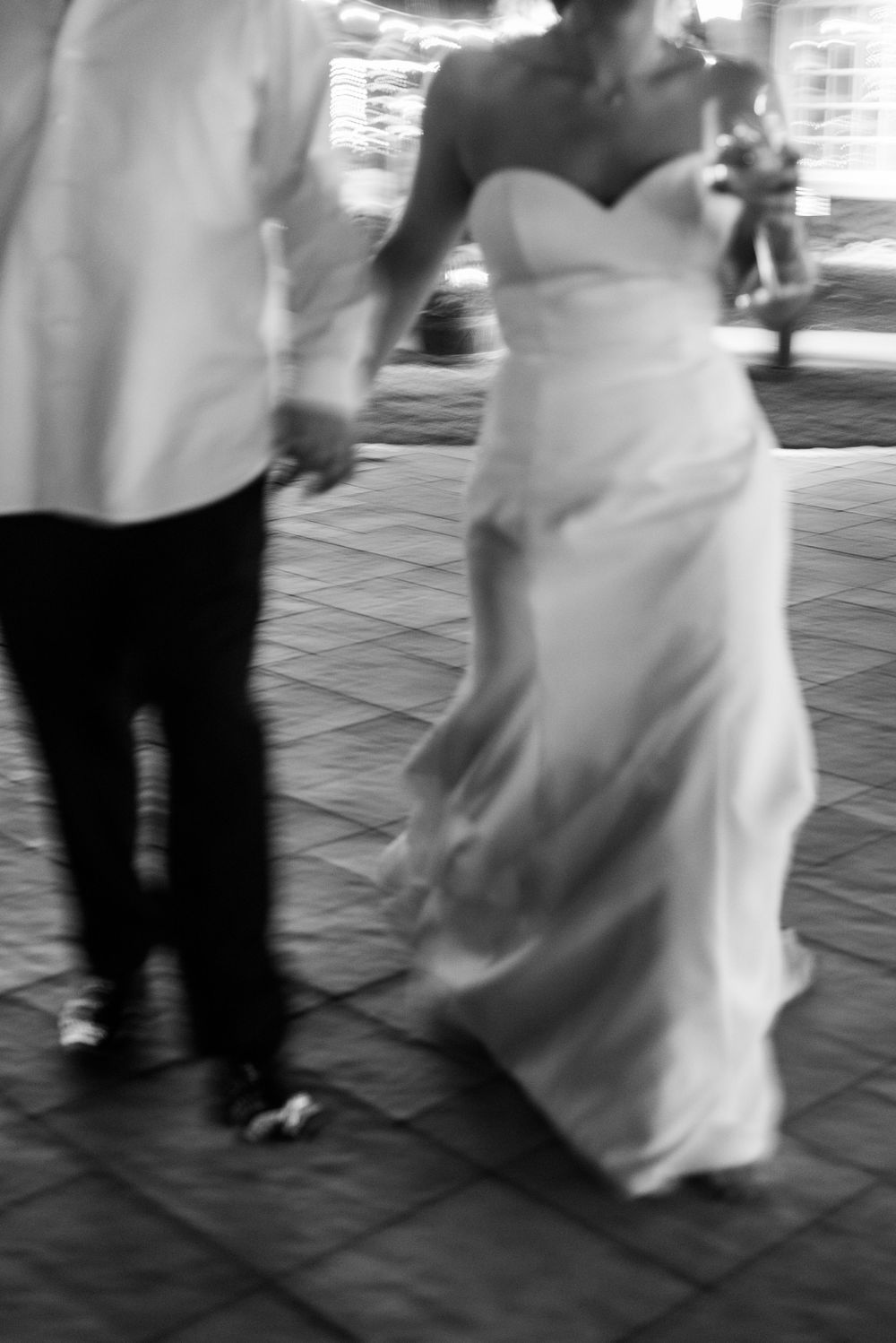 Black and white sequence of wedding dance movements on a tiled floor.