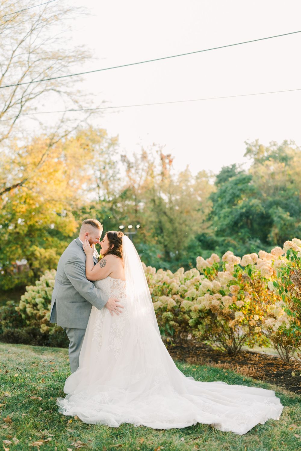Wedding couple sharing intimate moments in a garden with autumn colors at the mill event center lancaster ohio