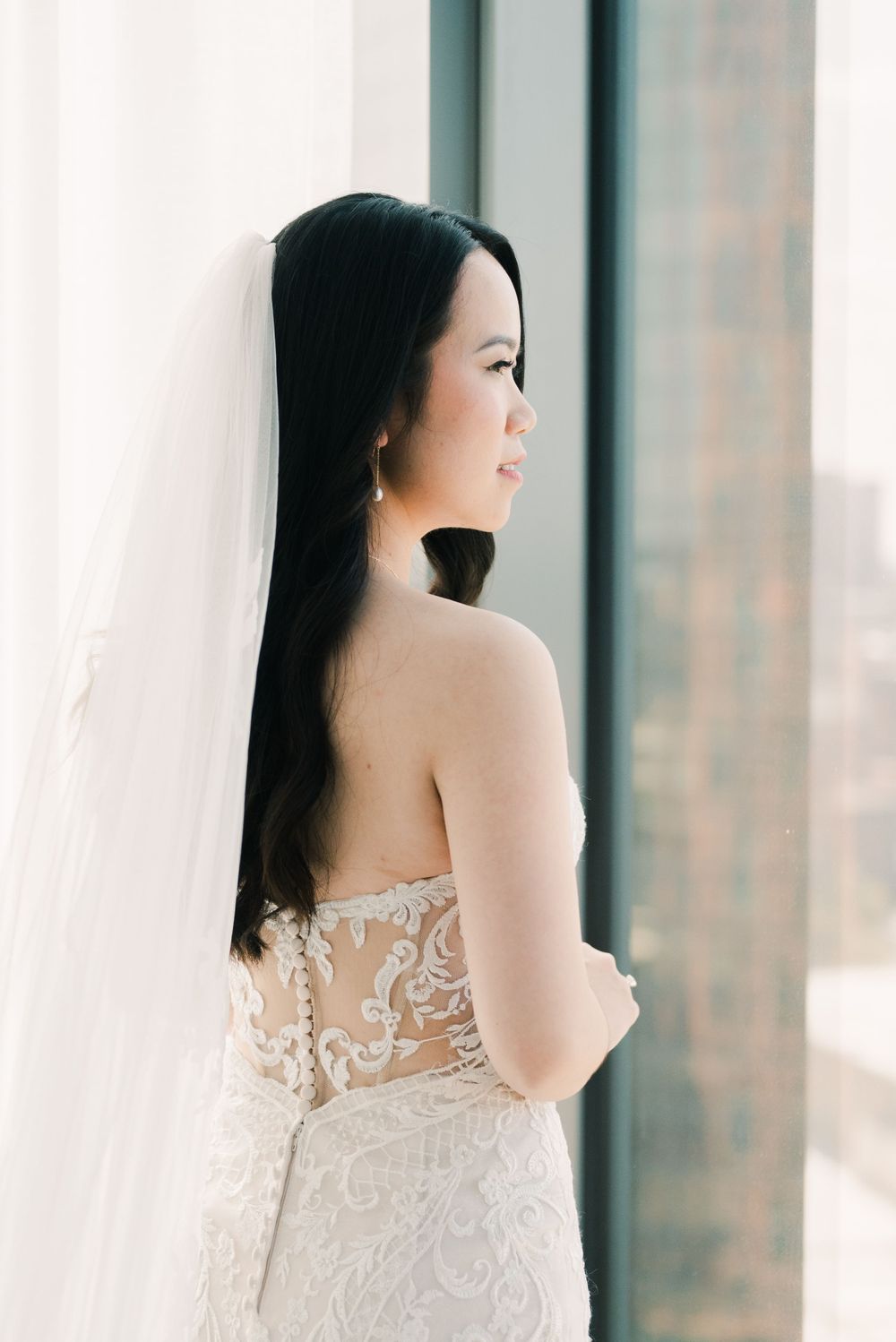 Delicate lace details of a strapless wedding gown shown in soft window light at hilton downtown columbus