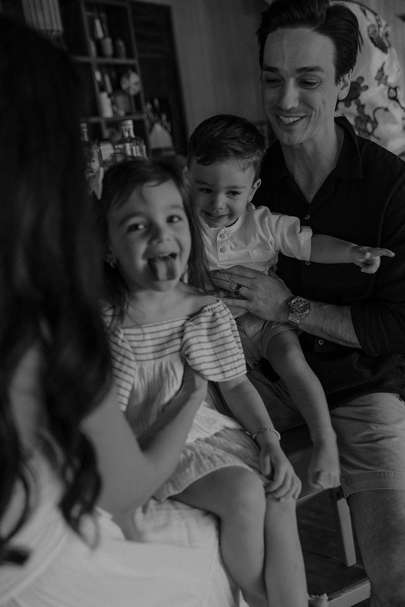 Black and white editorial portrait of family sharing joyful moment at La Zebra Tulum.