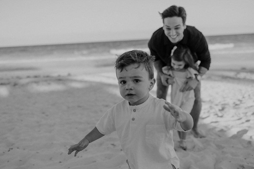 Little boy running on the sand during editorial family beach photoshoot in Tulum, Riviera Maya.