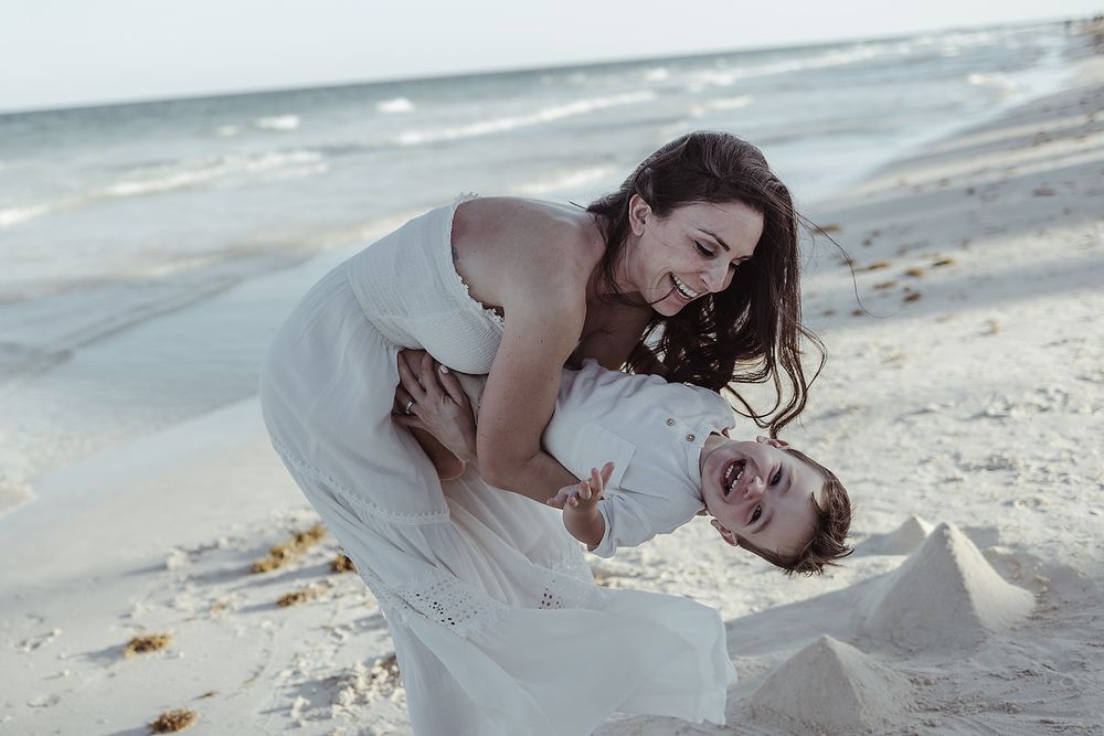Mother embracing child on the beach during editorial family session at La Zebra Hotel in Tulum.