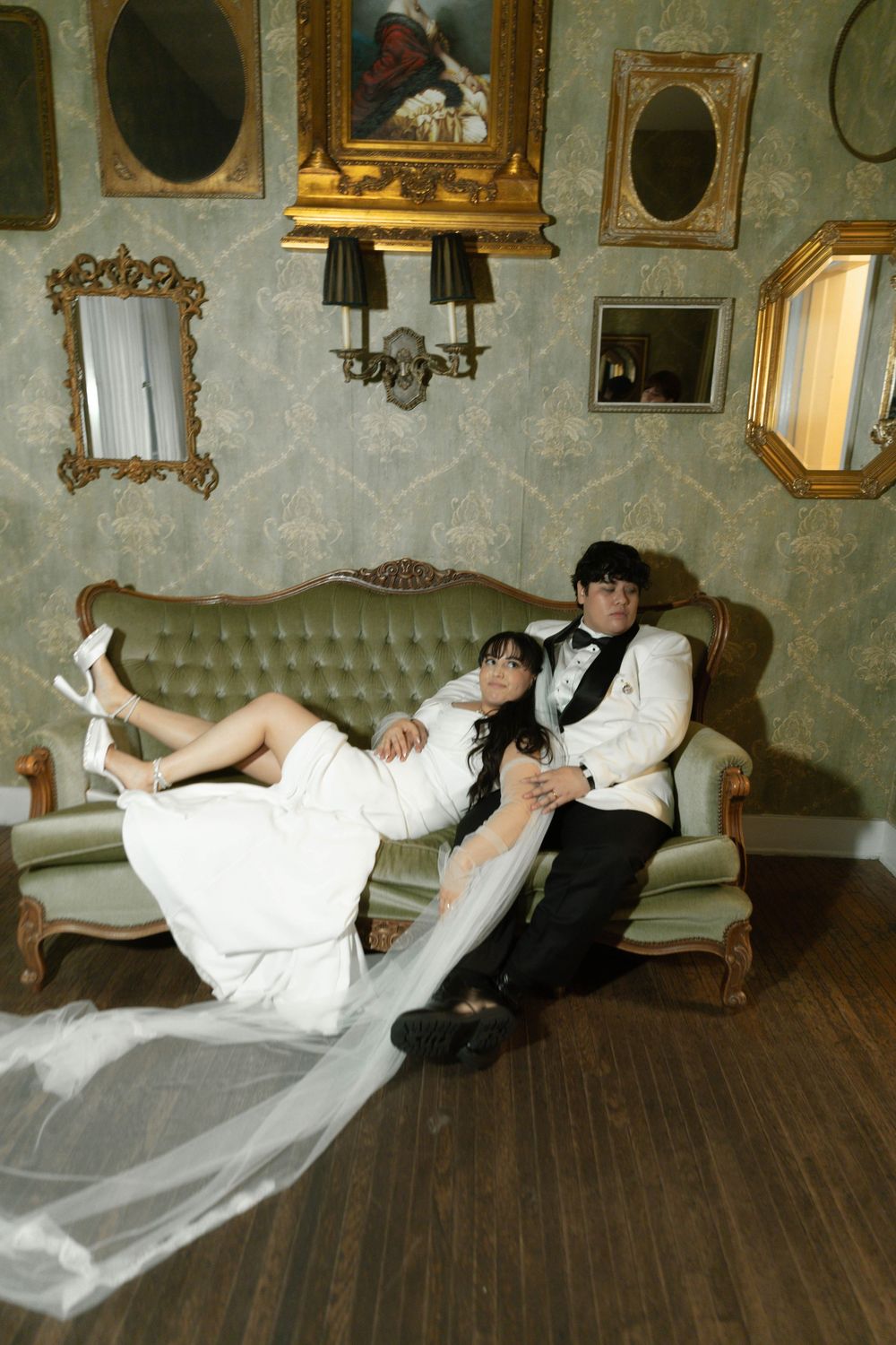 A sequence showing figures in formal attire dancing backwards in a vintage room with ornate wall decorations.