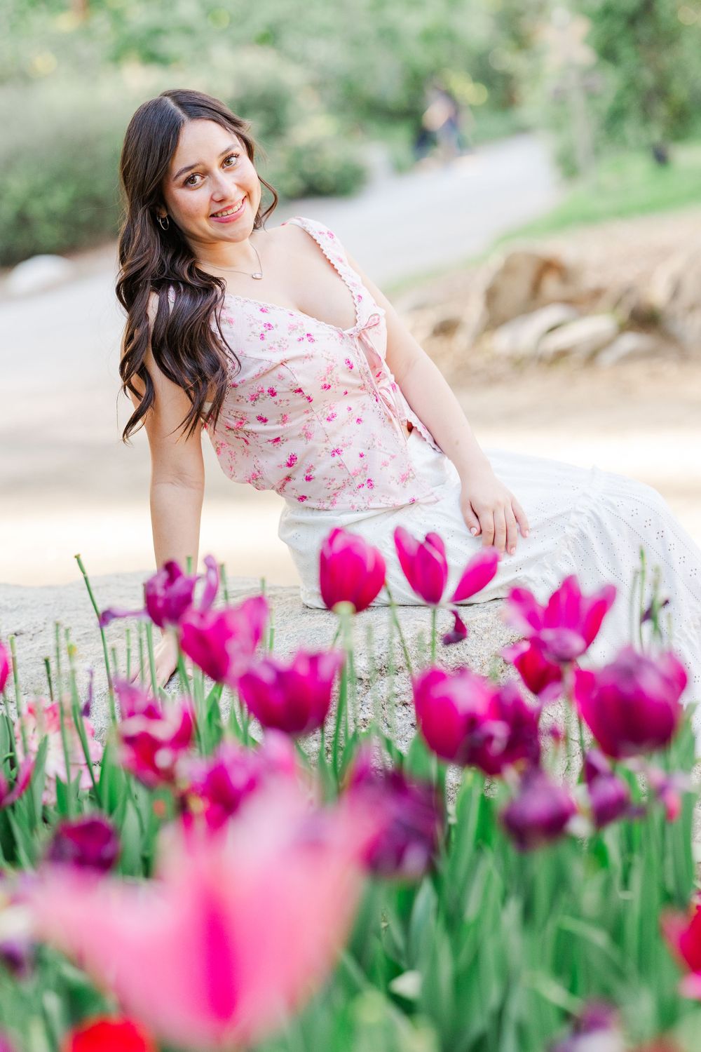 Beautiful spring scene with bright pink tulips blooming in a garden path on a sunny afternoon.