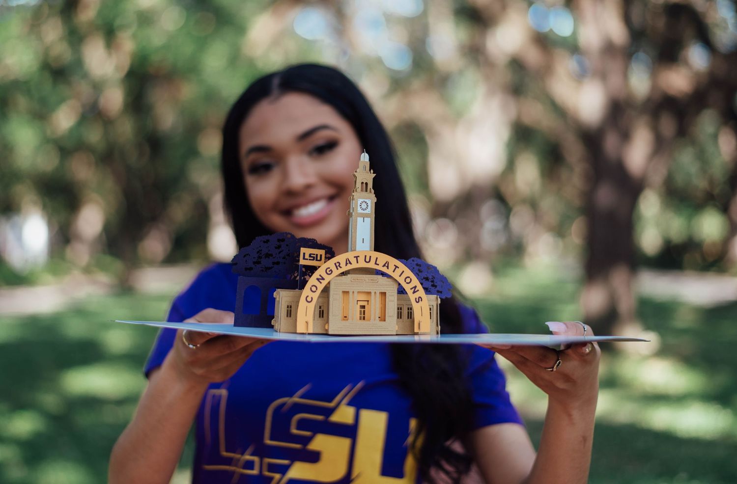 Houston High School Senior Posing with Her College Memorabilia