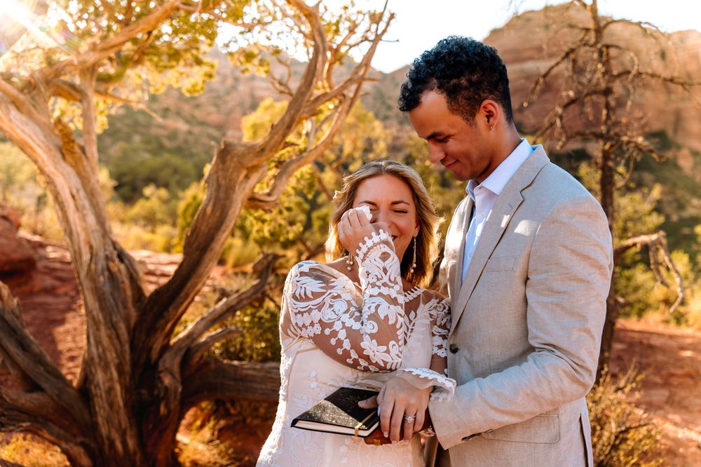 Intimate wedding moment shared during golden hour in Sedona desert landscape.