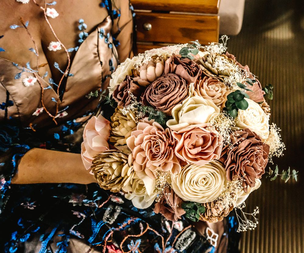 A romantic bouquet featuring dusty rose and cream-colored roses with delicate greenery.