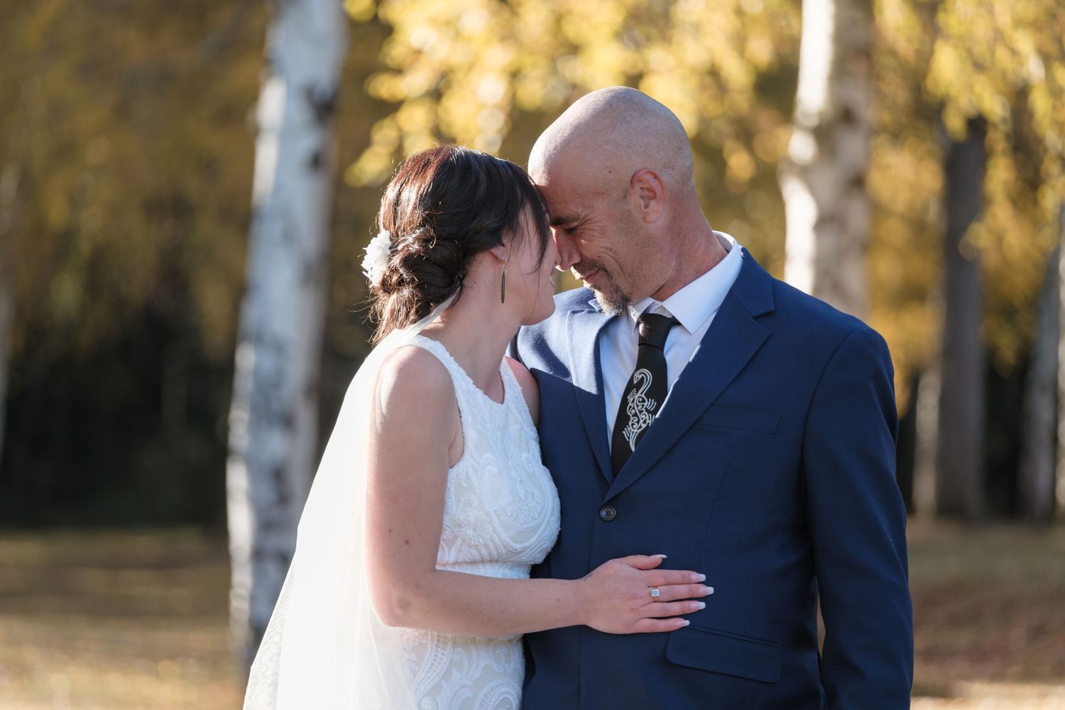 autumn trees and golden light backdrop to wedding photo