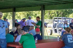 People gathered under a covered pavilion area during an outdoor festival event.