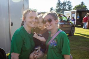 Event staff in green shirts working at a hot air balloon festival.