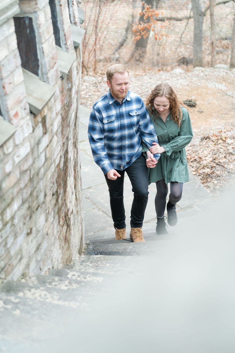Couple walking hand-in-hand along a winding path at the Minnesota Landscape Arboretum in early spring