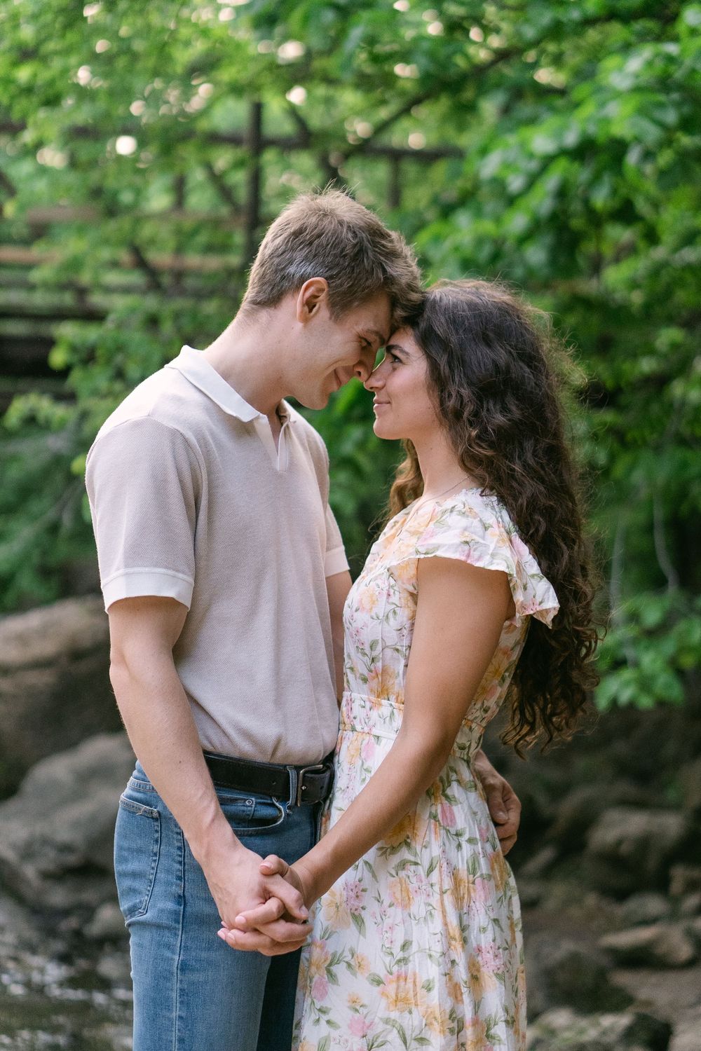 Silhouetted engagement portrait with forest backdrop and waterfall mist at Willow River in Hudson