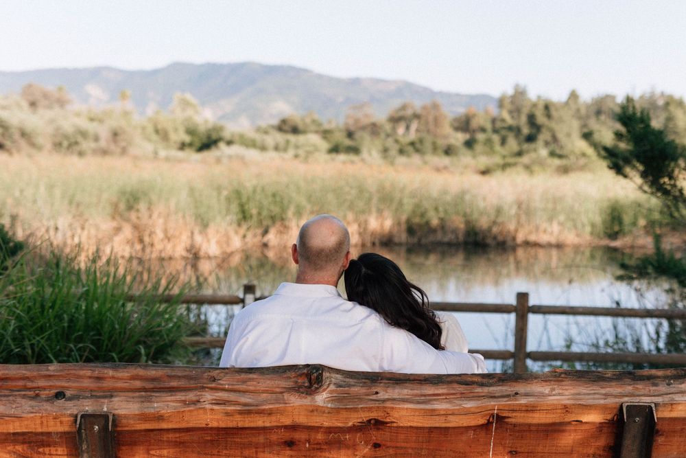 Ojai film photographer capturing a quiet moment of the couple watching ducks in the meadow.