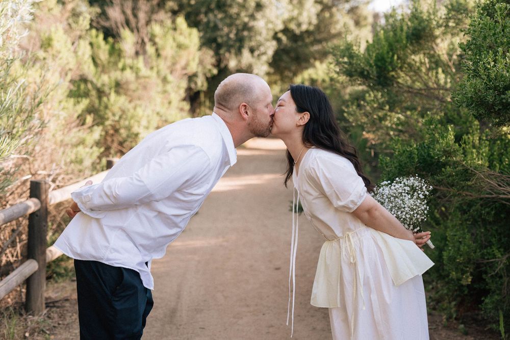 Candid and silly kiss at Ojai Meadows Preserve, captured on 35mm film by a local photographer.