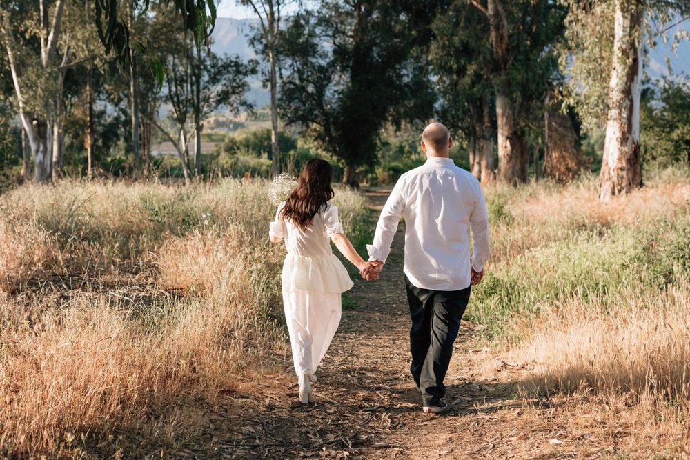 35mm film photo of couple walking through golden grass at Ojai Meadows Preserve.