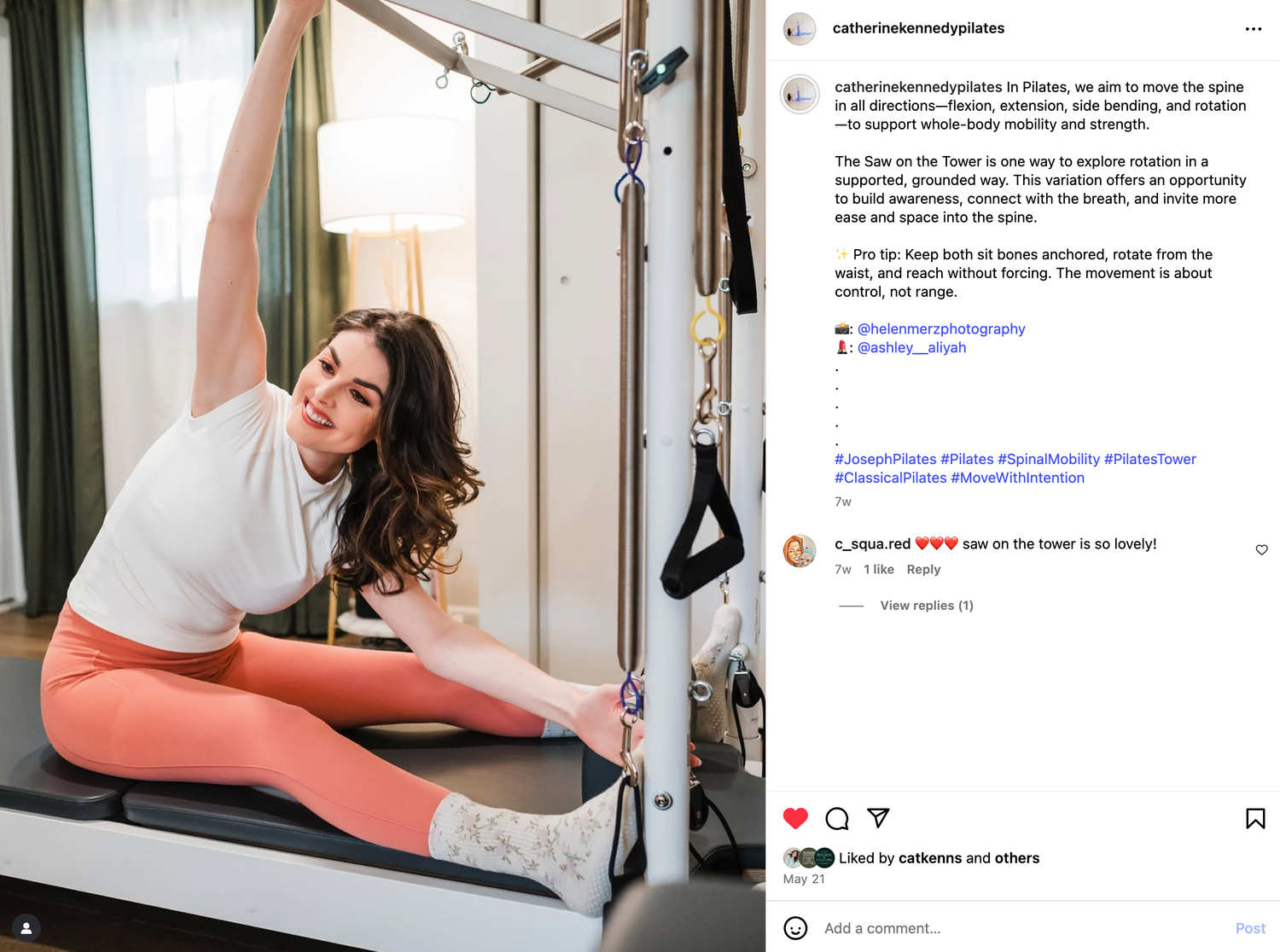 Physical therapy equipment including a pilates reformer and resistance bands mounted on a white wall in a clinical setting.