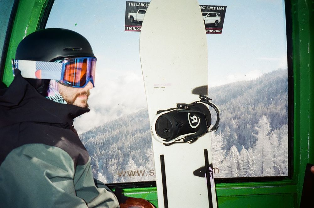 Interior view of ski lift gondola with mountain landscape through window.