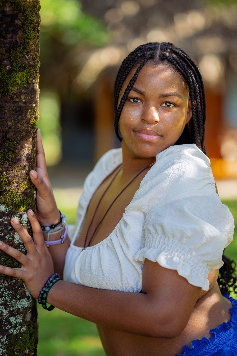 A series of outdoor portrait photos featuring a person in a white top posing against a natural background in a park setting.