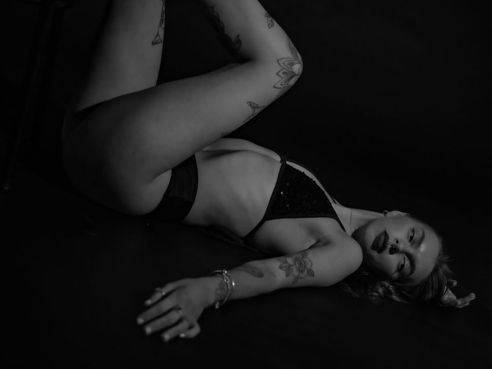 Intimate black and white portrait series showing graceful reclining poses.