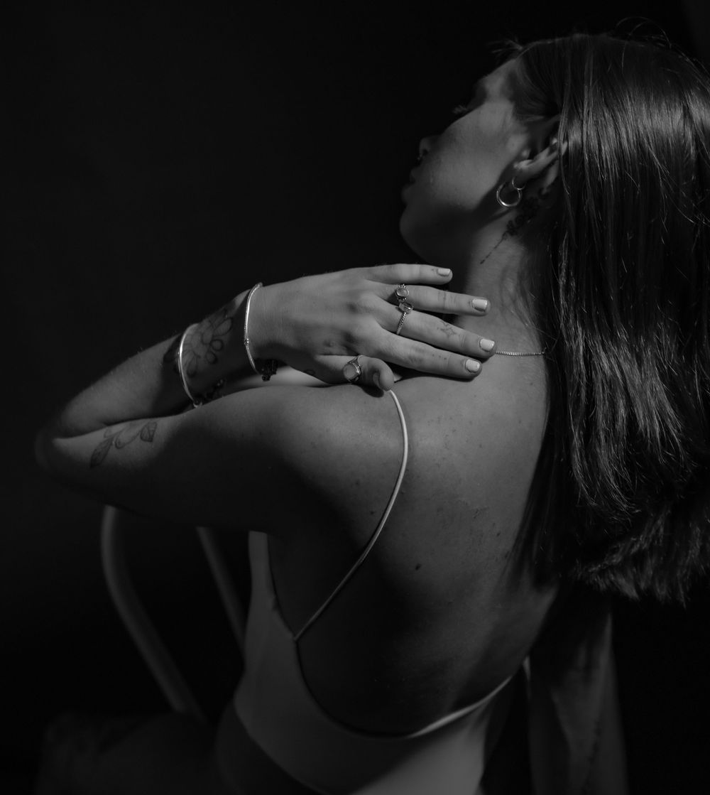 Minimalist black and white photography focusing on shoulder and neck poses.