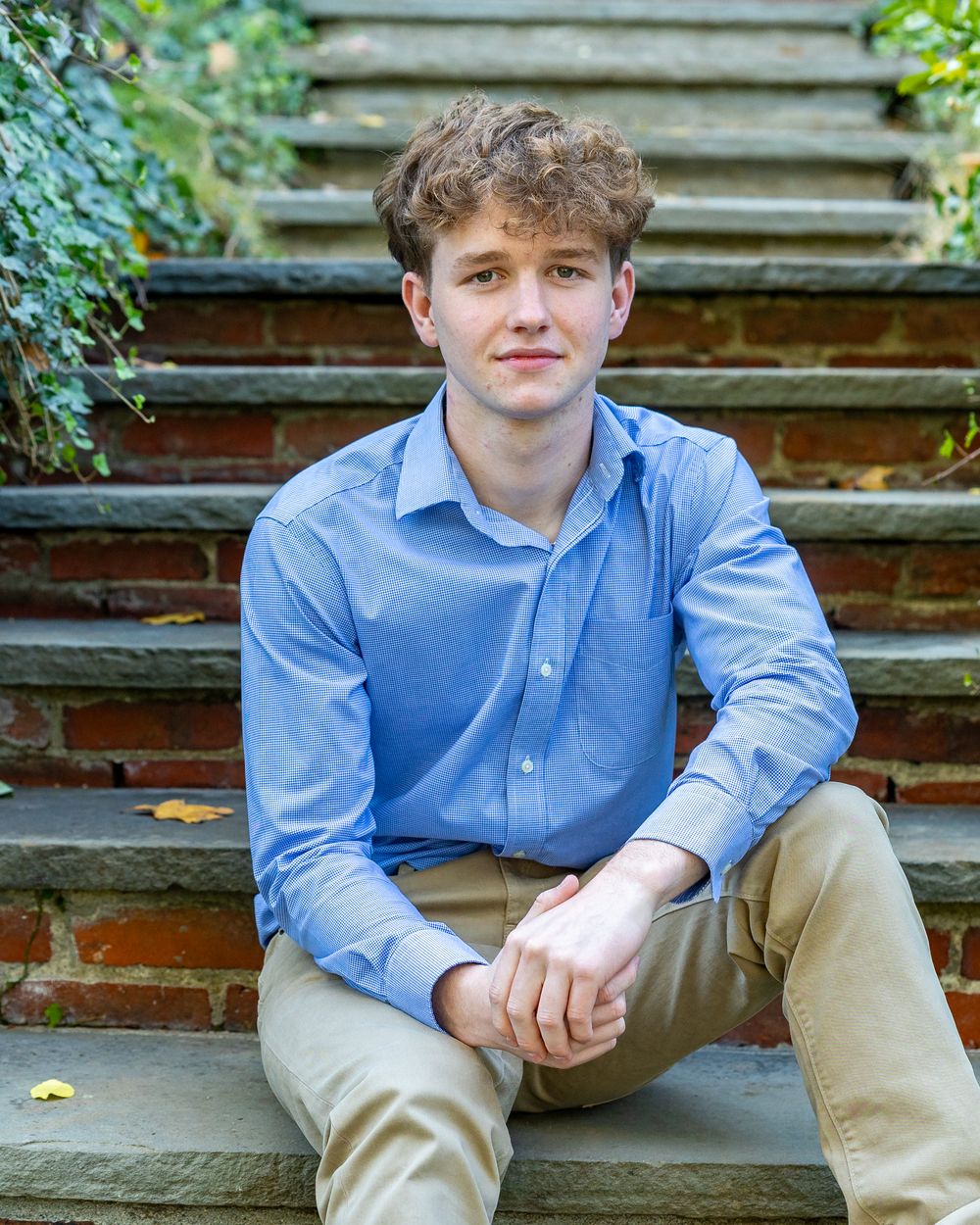 High School Senior poses for his yearbook portrait at Old North Bridge in Concord, MA in Metrowest of Boston with Lisa West Photography.
