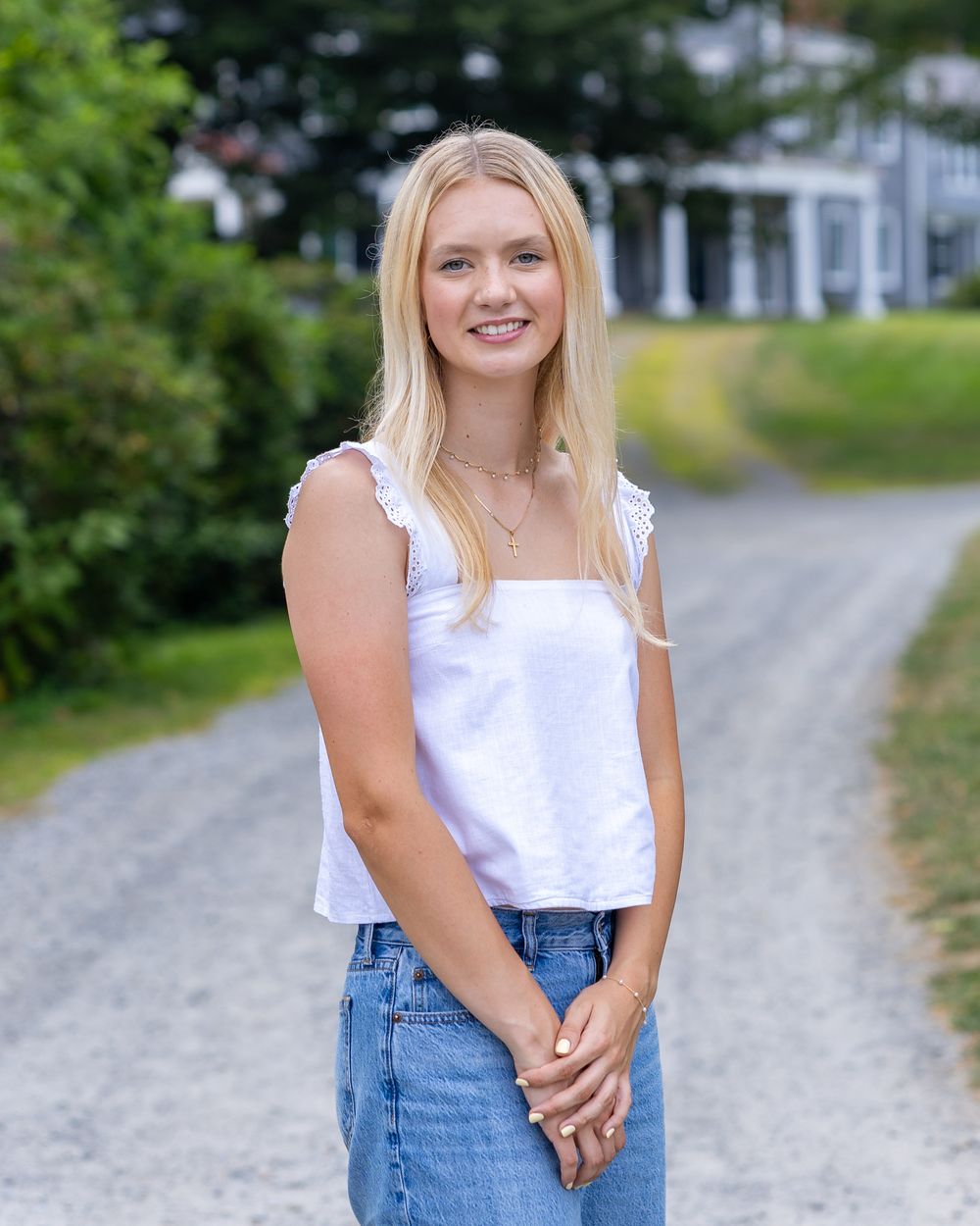 A high school senior poses for photos on the grounds Codman Estate in Lincoln, MA in a yearbook photos session with Lisa West Photography.