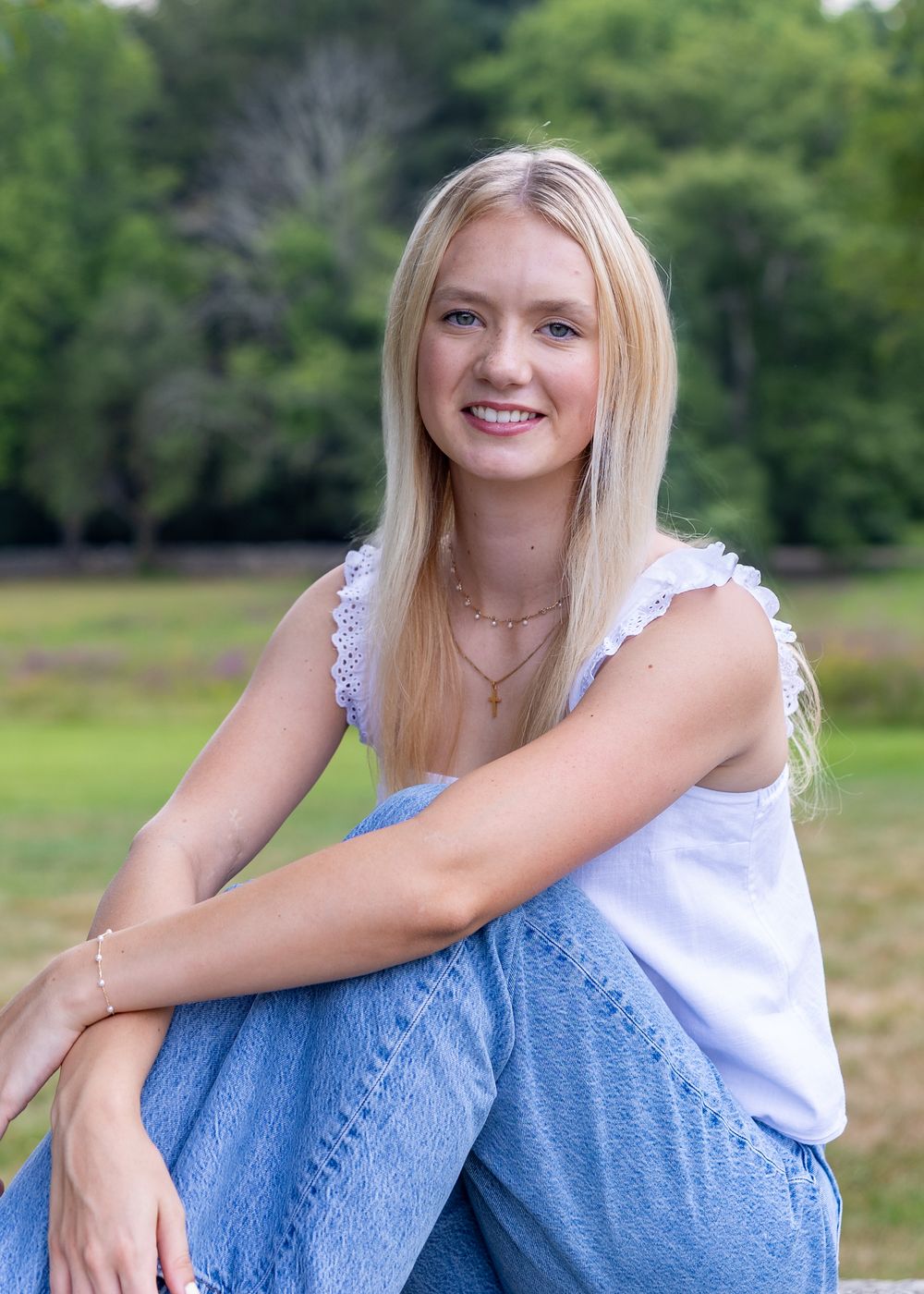 A high school senior poses for photos on the grounds Codman Estate in Lincoln, MA in a yearbook photos session with Lisa West Photography.