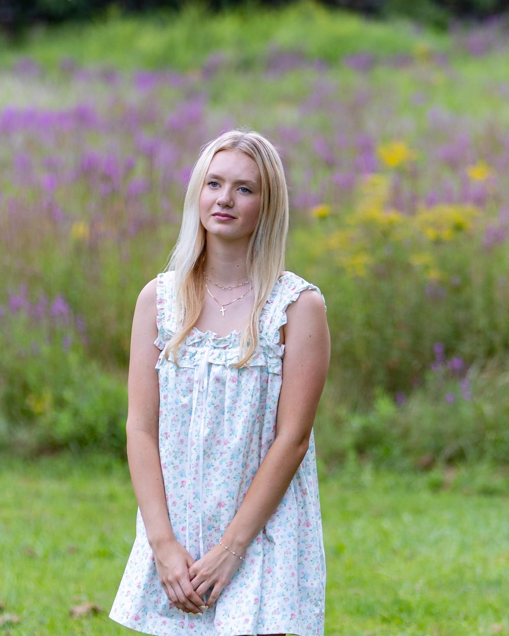 A high school senior poses for photos on the grounds Codman Estate in Lincoln, MA in a yearbook portrait session with Lisa West Photography.